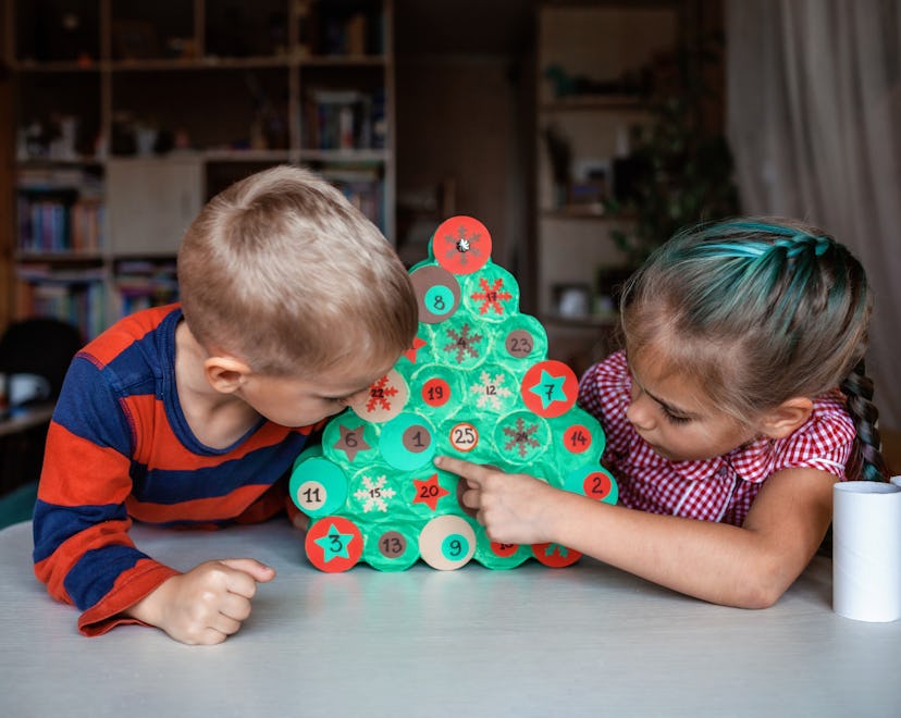 Kids looking at an advent calendar.