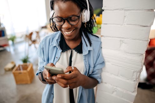 Young woman listening music at home office