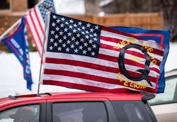 ST PAUL, MN - NOVEMBER 14: A car with a flag endorsing the QAnon drives by as supporters of Presiden...