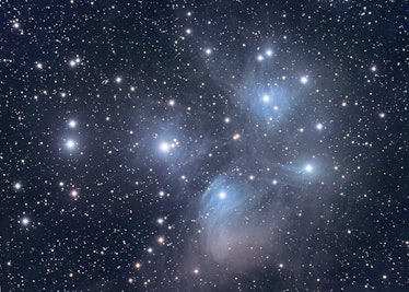 The Pleiades open star cluster in Taurus; a collection of stars moving through a dust/debris cloud i...