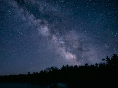 A meteor and the Milky Way over Lake Michigan in Wilderness State Park.  Wilderness State Park prese...