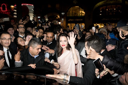 PARIS, FRANCE - JANUARY 30:  Actress Angelina Jolie is surrounded by the crowd as she leaves the 'Gu...