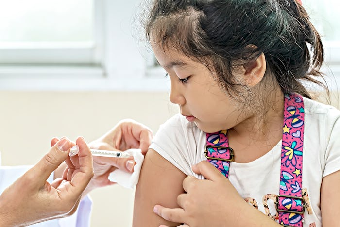 A girl is getting a Covid-19 vaccine.