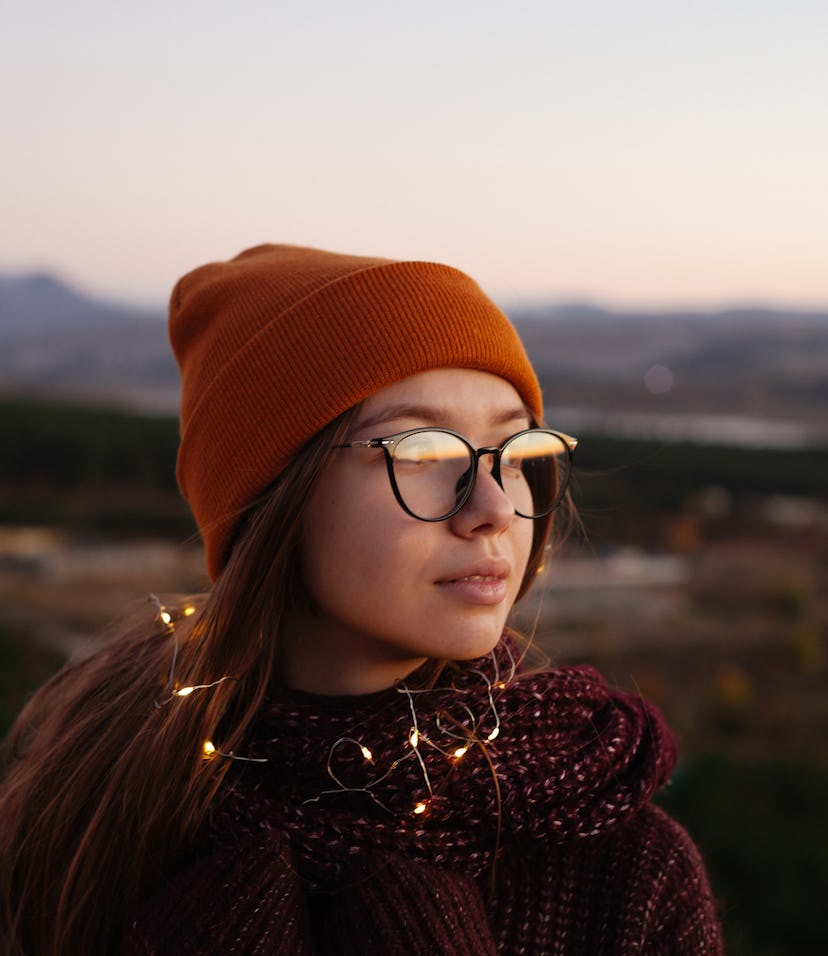Unlucky young woman in a beanie preparing for the worst Sagittarius season 2021, per her zodiac sign...