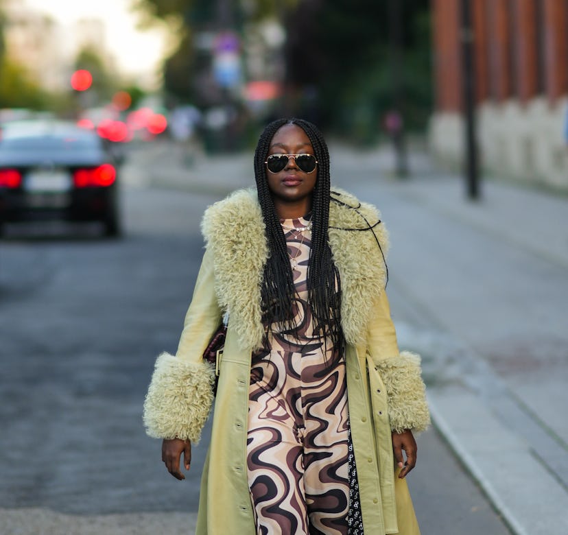 A guest wearing a coat during Paris Fashion Week. 