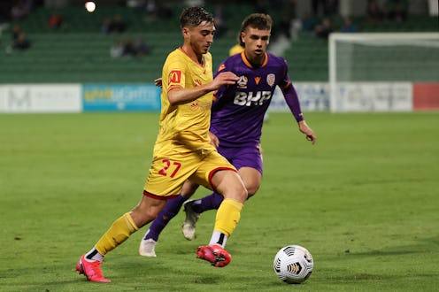 Josh Cavallo of Adelaide  controls the ball against Joshua Rawlins of the Glory during the A-League ...