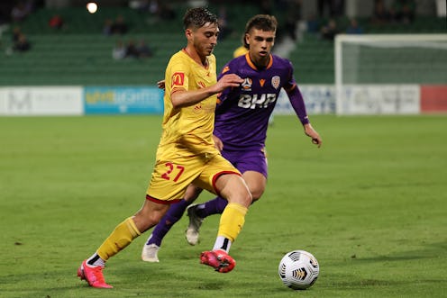 Josh Cavallo of Adelaide  controls the ball against Joshua Rawlins of the Glory during the A-League ...