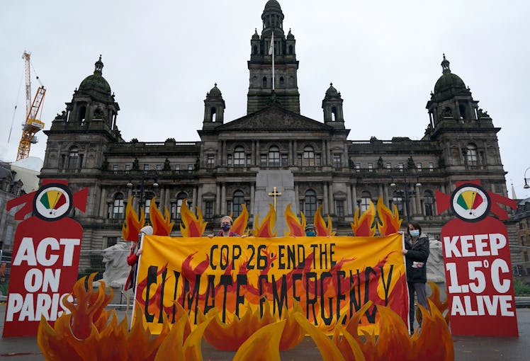 Climate activists "set fire" to George Square, Glasgow, with an art installation of faux flames, smo...