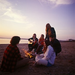 A group of teenagers tell spooky campfire stories while at a beach.