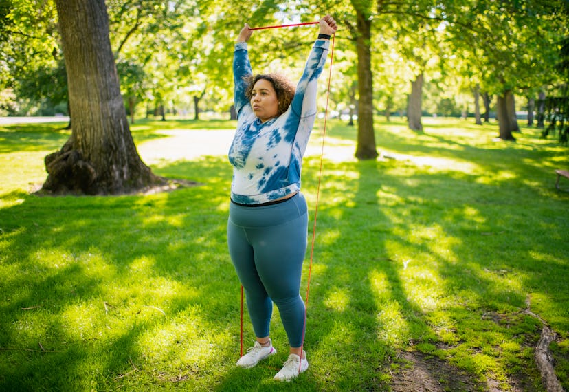 Stand on middle of band and press up to work triceps and shoulders.