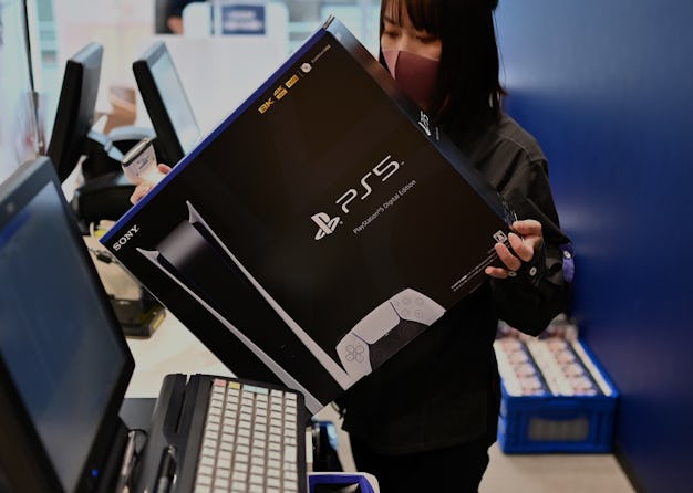 An employee prepares the new Sony PlayStation 5 gaming console for a customer on the first day of it...
