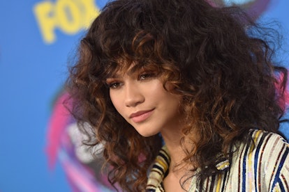 Zendaya with a curly shag-mullet hairdo.