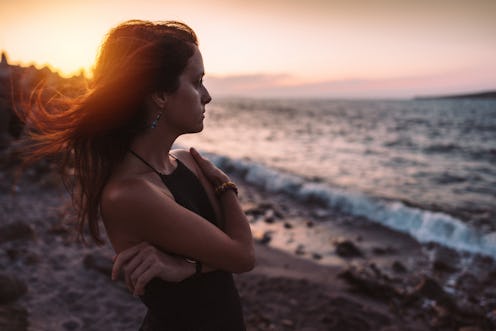 A woman stares moodily at the beach. An astrologer explains cancer zodiac signs' biggest weaknesses.