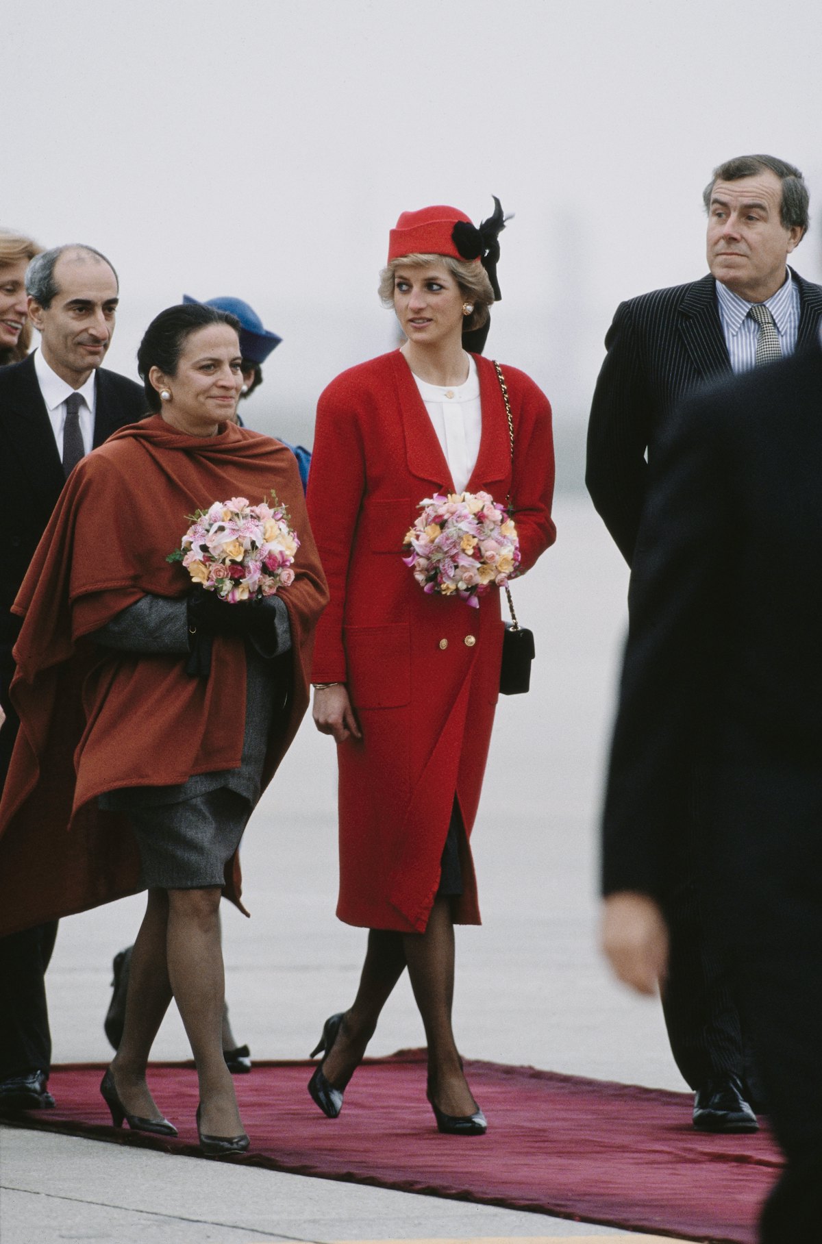 Princess Diana wearing a red Chanel outfit at Orly Airport near Paris, France, in November 1988.