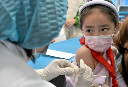 A child receives the Covid-19 coronavirus vaccine at a school in Handan, in China's northern Hebi pr...