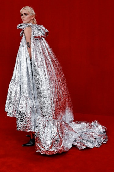 A model walking posing in a silver dress at the Balenciaga Ready to Wear Spring/Summer 2022 fashion ...