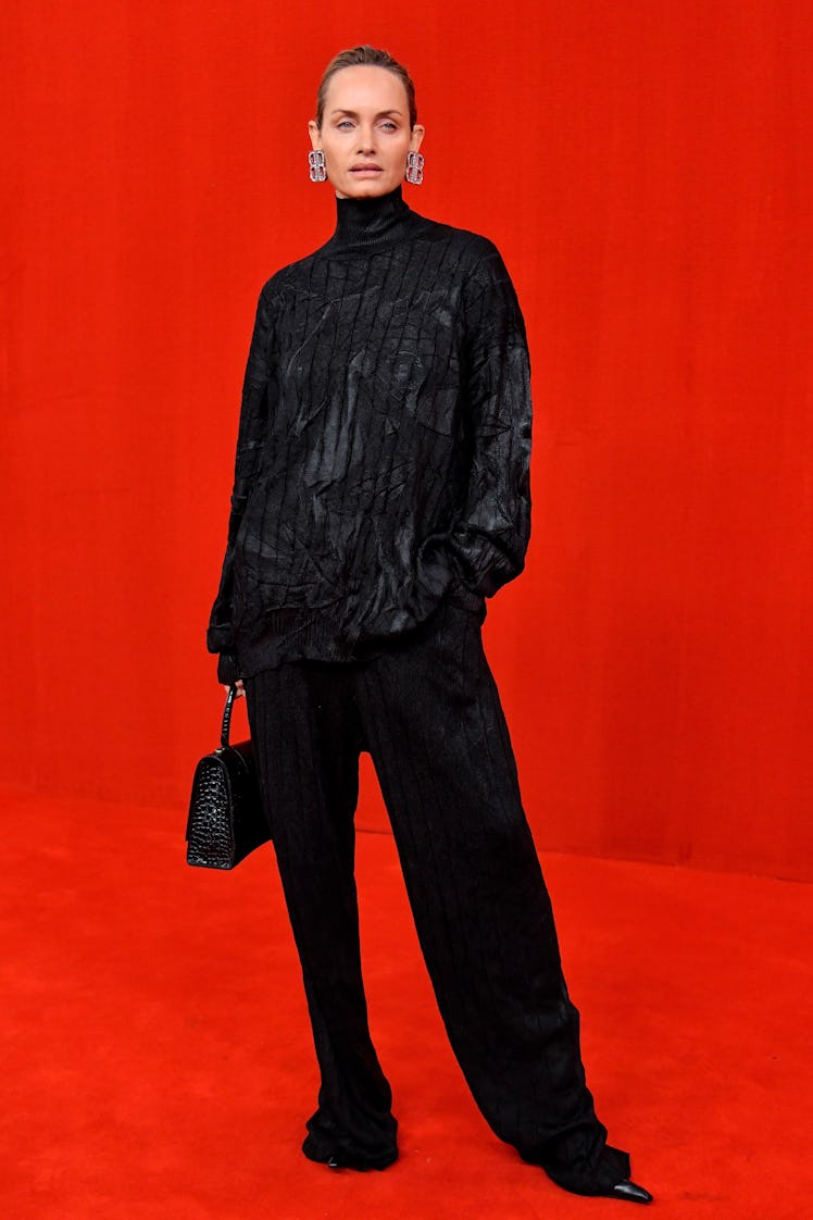 Amber Valletta walking in a black shirt and pants at the Balenciaga Ready to Wear Spring/Summer 2022...
