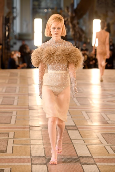 A model walking in a beige dress at the Rokh Womenswear Spring/Summer 2022 show