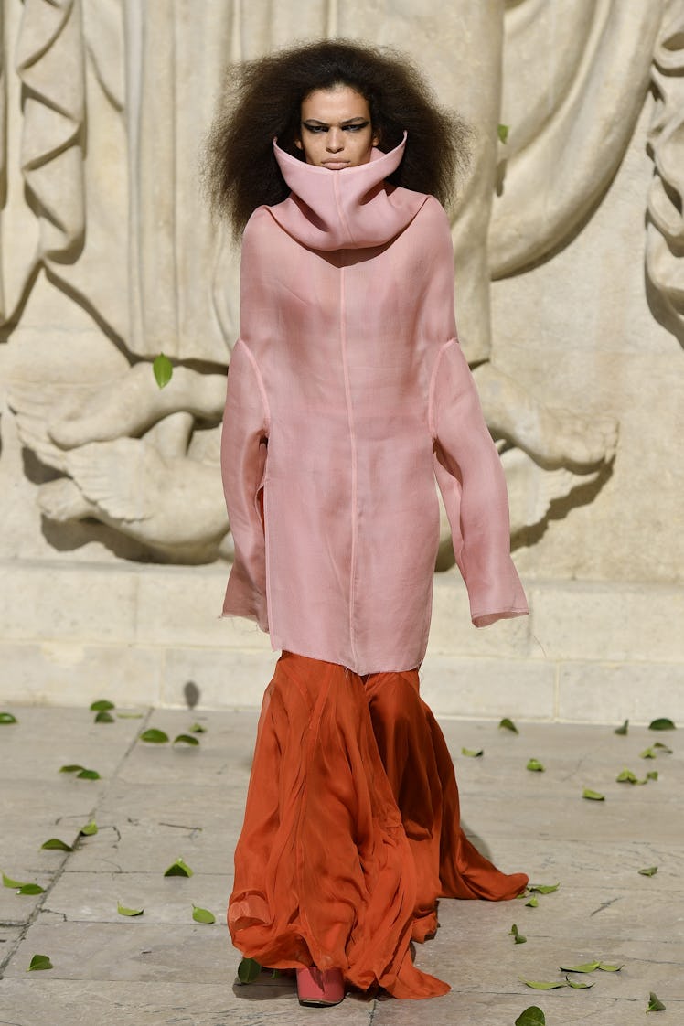 A model walking in a pink-orange dress at the Rick Owens Womenswear Spring/Summer 2022 show