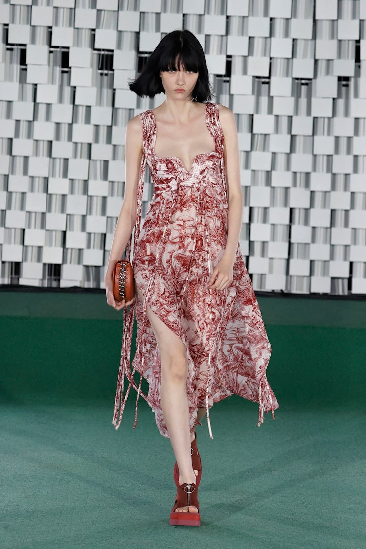 A model walking in a red-white dress at the Stella McCartney Womenswear Spring/Summer 2022 show