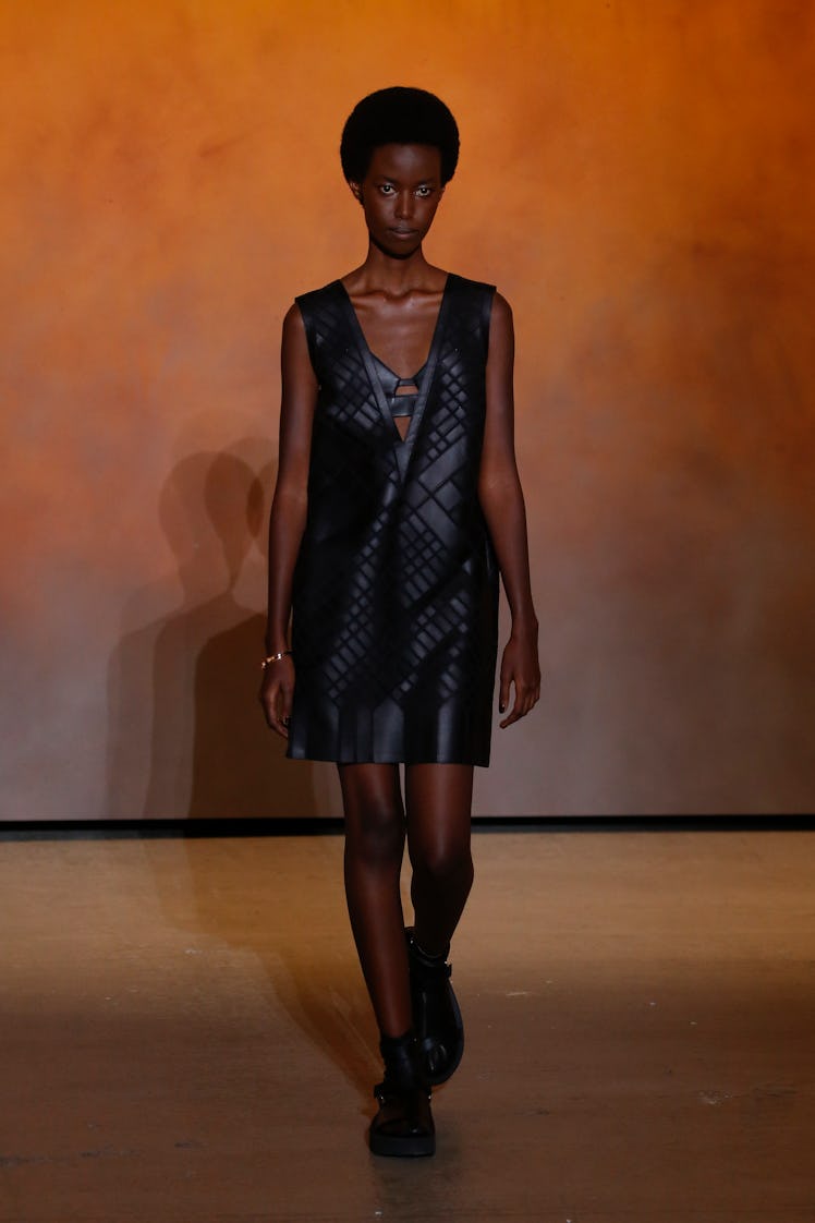 A model walking in black dress at the Hermes Ready to Wear Spring/Summer 2022 fashion show