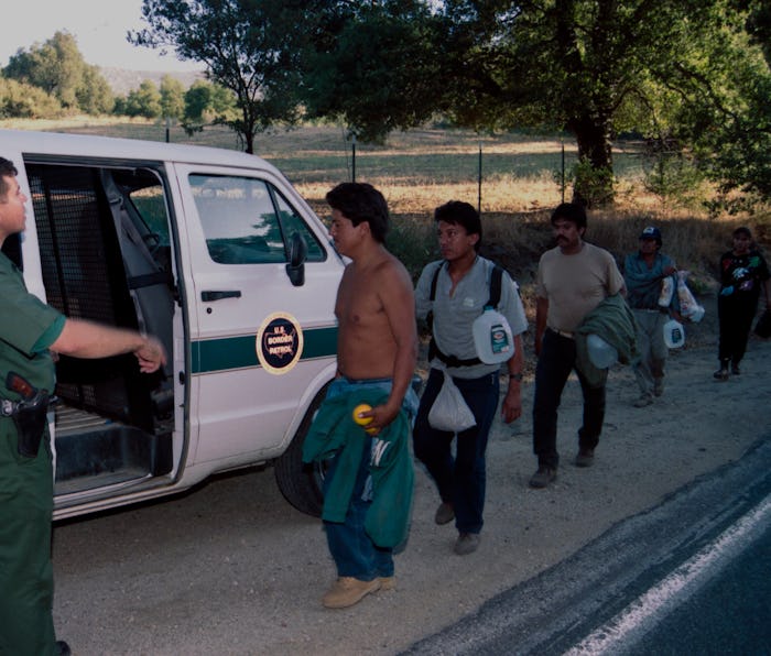 CAMPO, CALIFORNIA - JULY 20 : U.S. Border Patrol agent monitors a group of undocumented migrants arr...