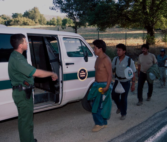 CAMPO, CALIFORNIA - JULY 20 : U.S. Border Patrol agent monitors a group of undocumented migrants arr...