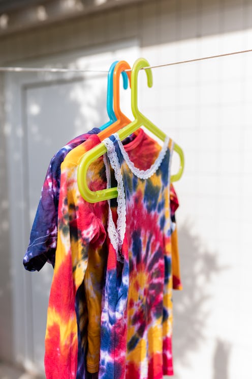 Young woman making tie dye clothes at home
