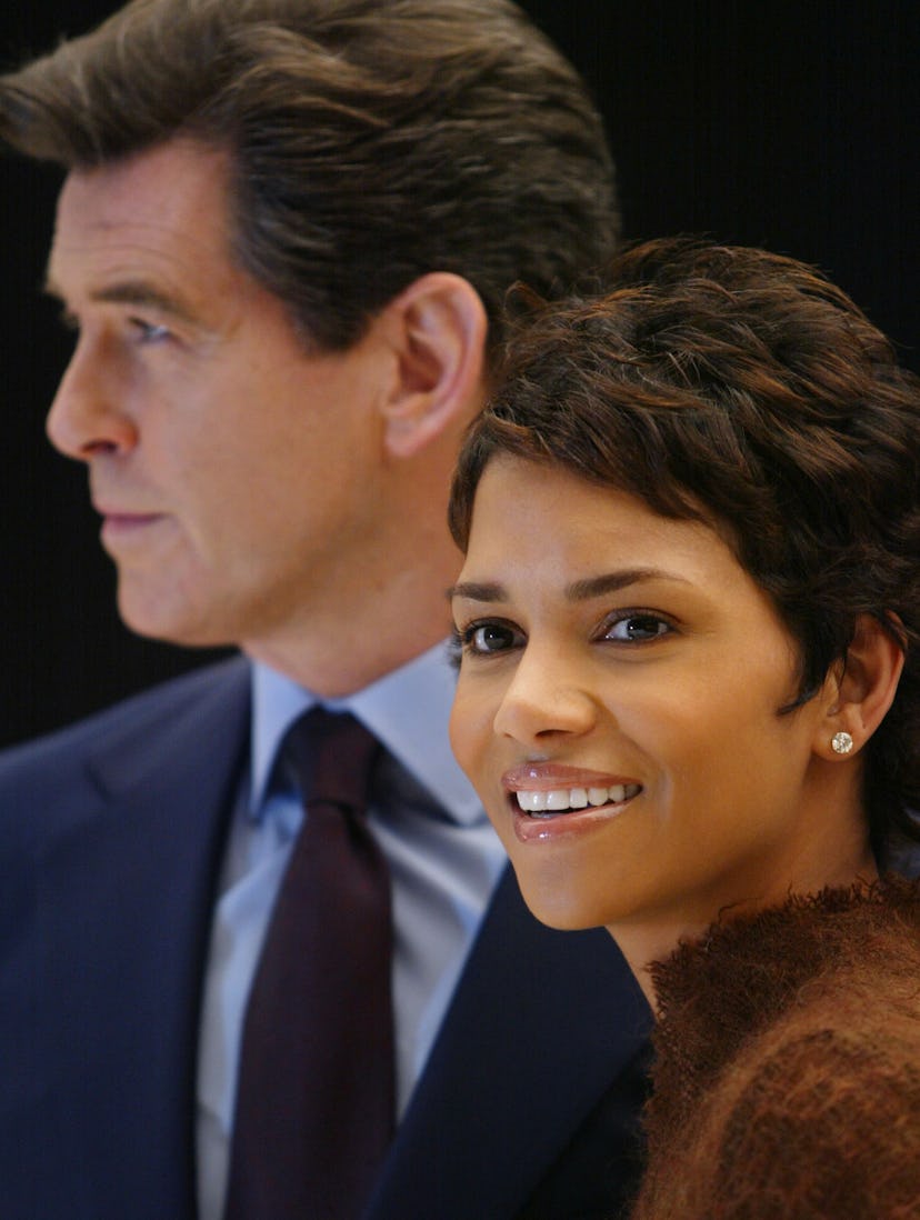 Pierce Brosnan (L) and Halle Berry (R) smile during a photocall at Pinewood Studios, 11 January 2002...
