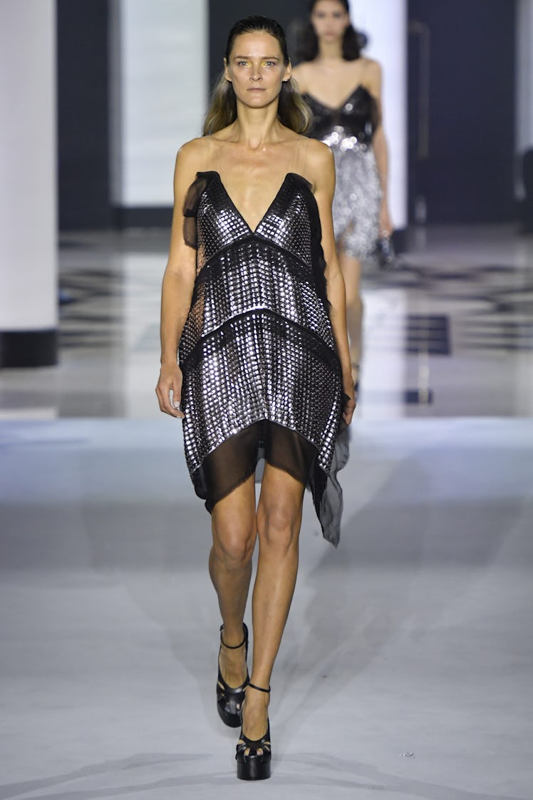 Carmen Kass walking in a black dress at the Lanvin Ready to Wear Spring/Summer 2022 show 