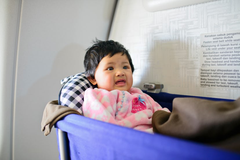 baby in airplane bassinet
