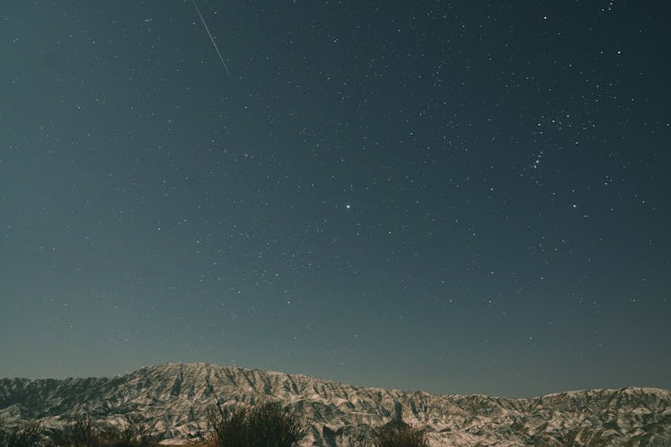 BAYINGOLIN, CHINA - JANUARY 04: A shooting star is seen at Bosten Lake scenic area as Quadrantid met...