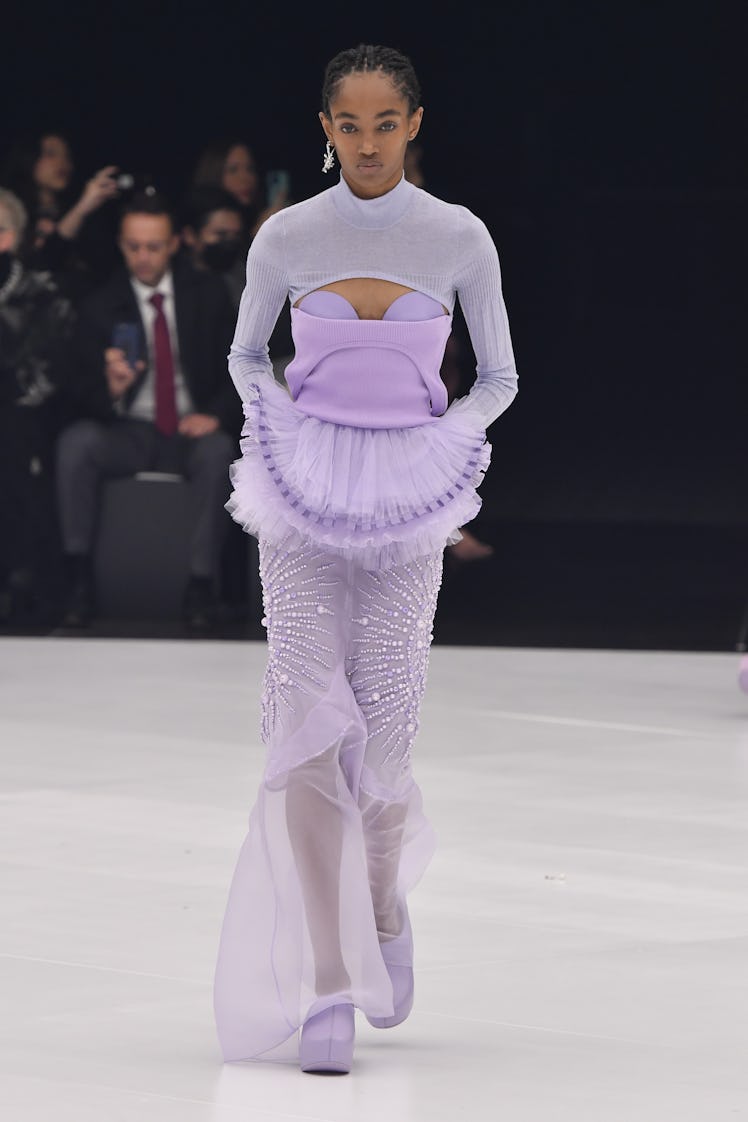 A model walking in a lavender top and skirt at the Givenchy Ready to Wear Spring/Summer 2022 fashion...