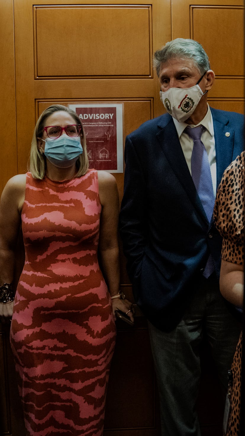 WASHINGTON, DC - SEPTEMBER 30: Sen. Kyrsten Sinema, D-Ariz., and Sen. Joe Manchin, D-W.Va., board an...