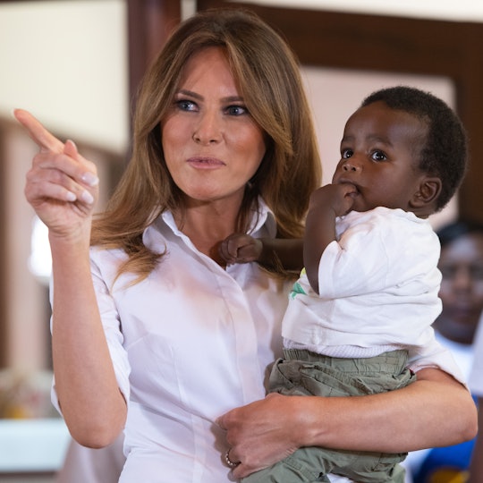 US First Lady Melania Trump holds a baby as she visits the Nest Childrens Home Orphanage, which prim...