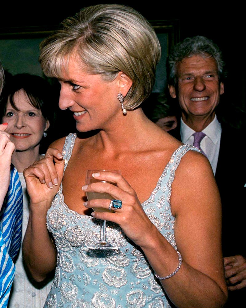 Princess Diana wears her tennis bracelet at an auction in June 1997.