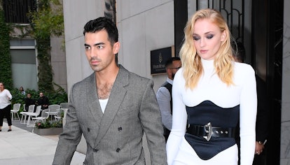 Sophie Turner wears white dress and black corset while walking in SoHo with husband Joe Jonas on Aug...