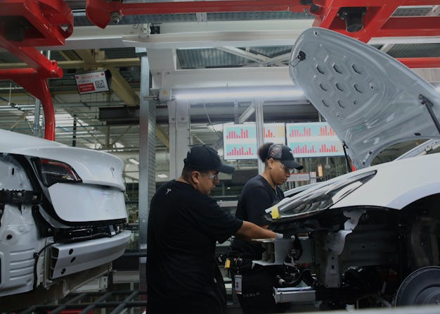 Production associates work on a Tesla Model 3 at the Tesla factory on Wednesday, July 18, 2018 in F...