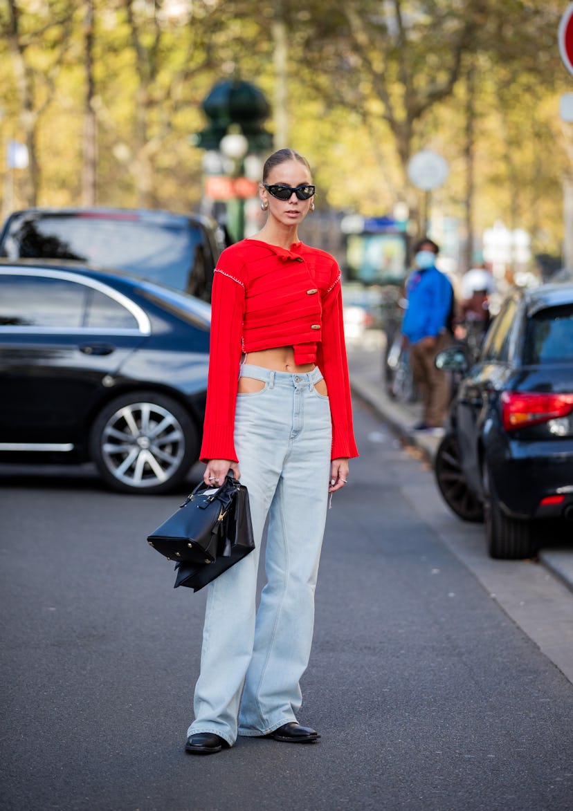 PARIS, FRANCE - SEPTEMBER 28: Hilda Sandström is seen wearing red top, denim jeans, black bag outsid...