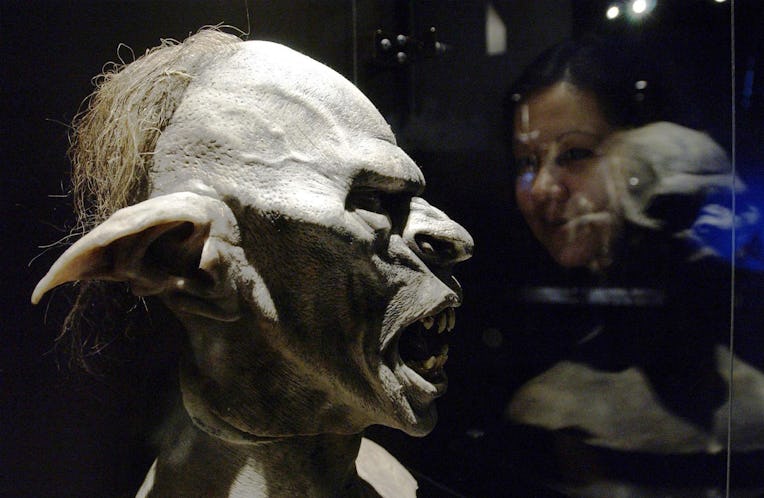 A visitor examines a model of an orc during a photocall for the launch of The Lord Of The Rings: The...