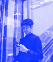 Confident asian man using elevator a corridor in an airport while on a business trip