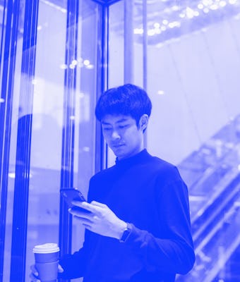 Confident asian man using elevator a corridor in an airport while on a business trip