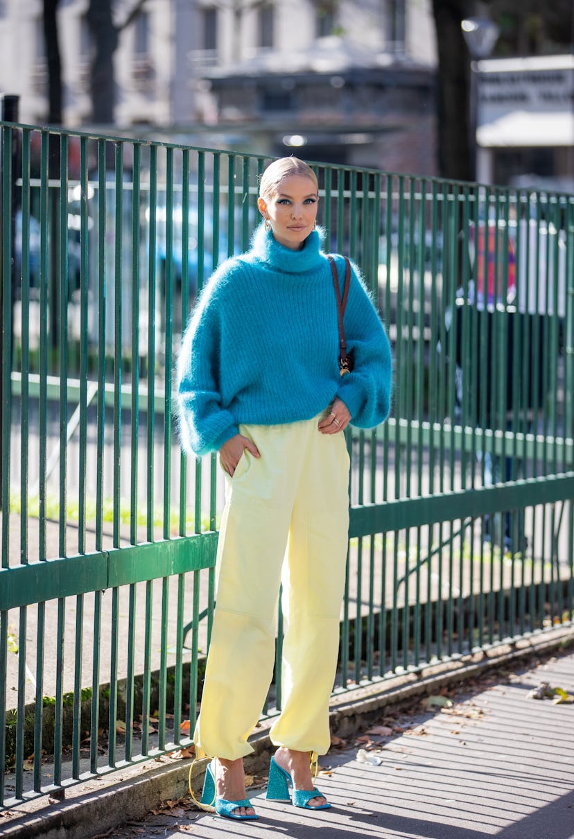 PARIS, FRANCE - OCTOBER 04: Leonie Hanne seen wearing blue knitted turtleneck, yellow pants, heels o...