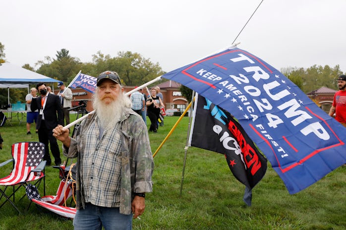 Supporters of former US President Donald Trump protest the visit of US President Joe Biden to Howell...
