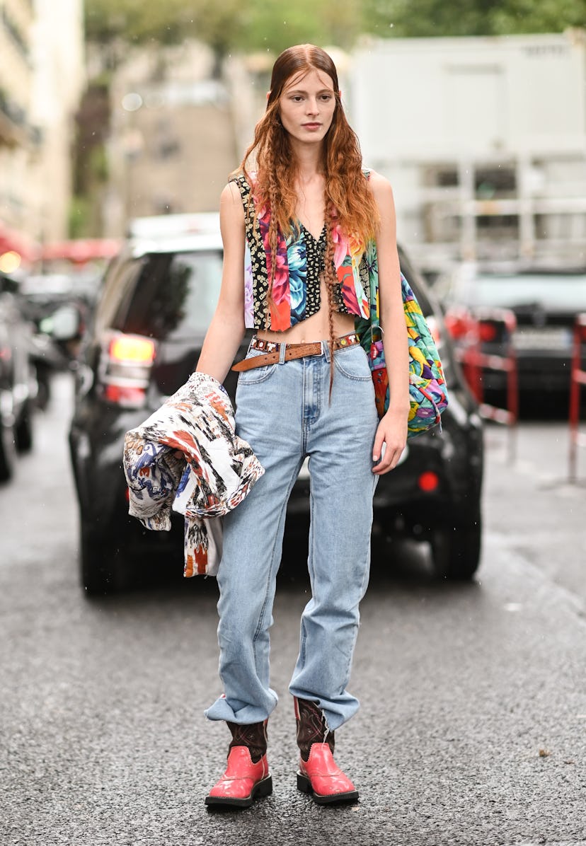 PARIS, FRANCE - SEPTEMBER 29: Model Clementine Balcaen is seen wearing a floral graphic vest, blue j...