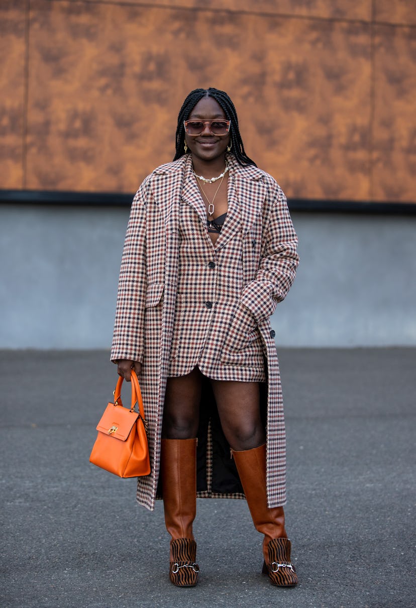 PARIS, FRANCE - SEPTEMBER 30: Lois Opoku seen waring checkered coat and blazer, orange bag, boots ou...