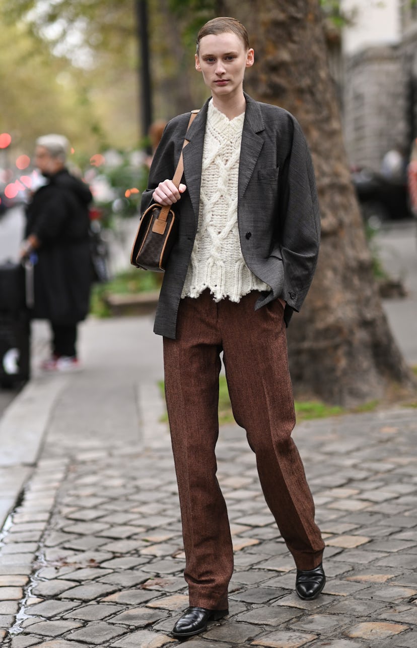 PARIS, FRANCE - OCTOBER 01: Model Kaila Wyatt is seen wearing a gray jacket, white sweater, brown pa...