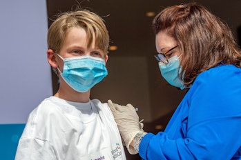 Charles Muro,age 13, is inoculated by Nurse Karen Pagliaro at Hartford  Healthcares mass vaccination...