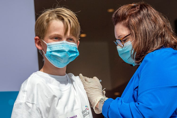 Charles Muro,age 13, is inoculated by Nurse Karen Pagliaro at Hartford  Healthcares mass vaccination...