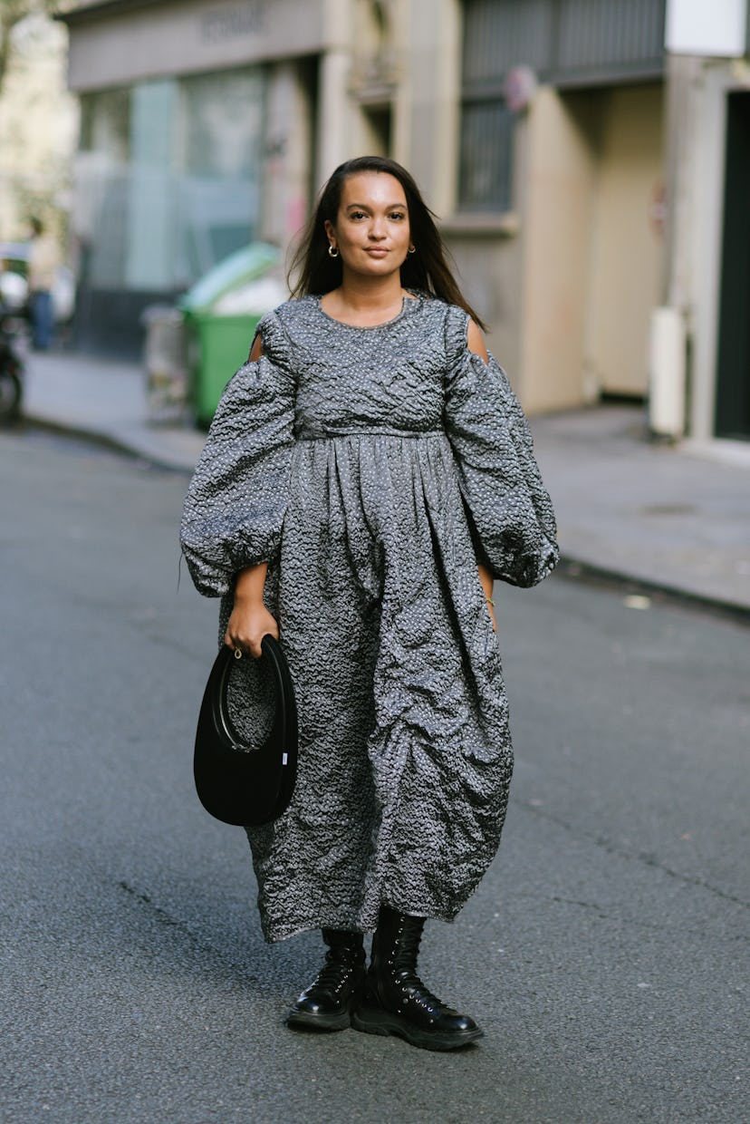 PARIS, FRANCE - SEPTEMBER 29: A guest poses wearing Cecilie Bahnsen and a Coperni bag after the Ceci...